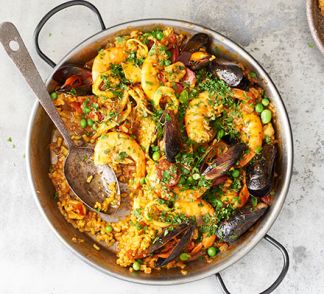 Paella with prawns and mussels served in a pan